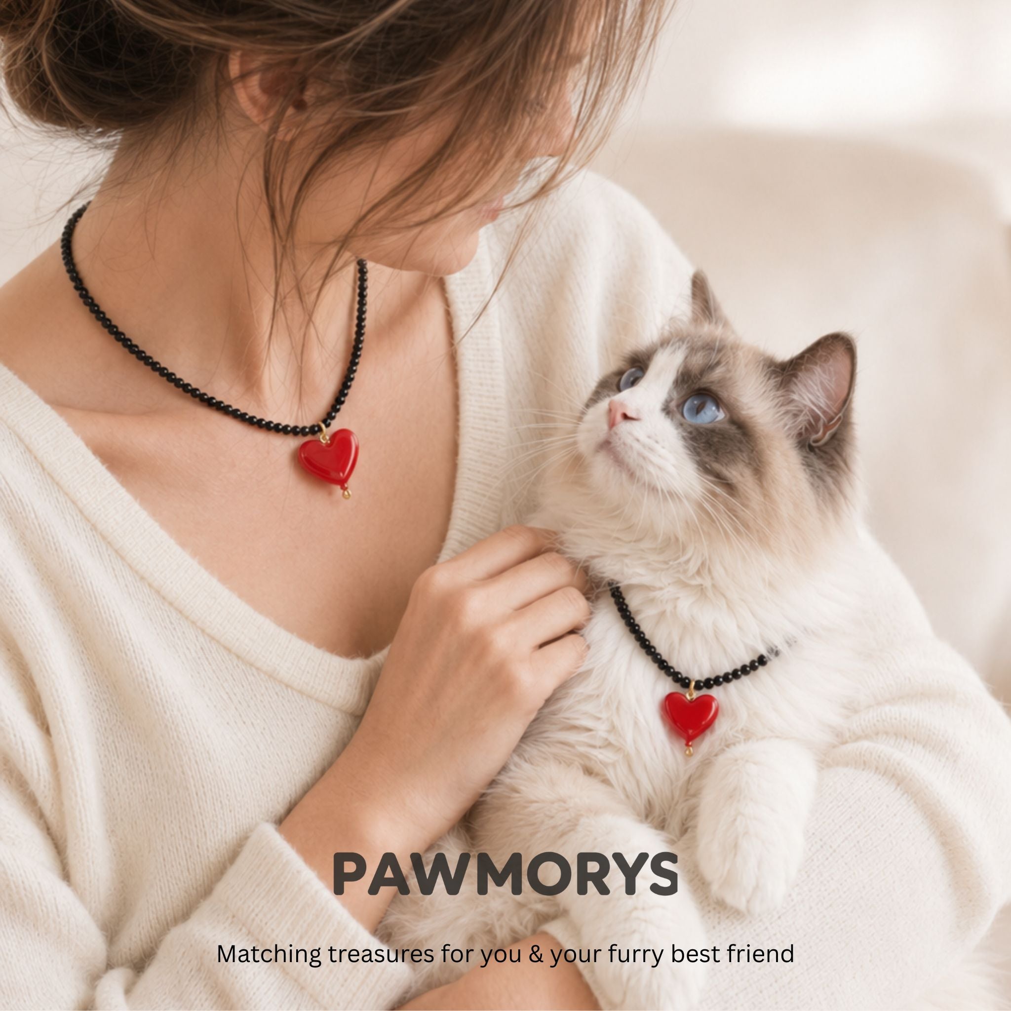 Woman and Ragdoll cat wearing matching black American Sweetheart heart necklaces